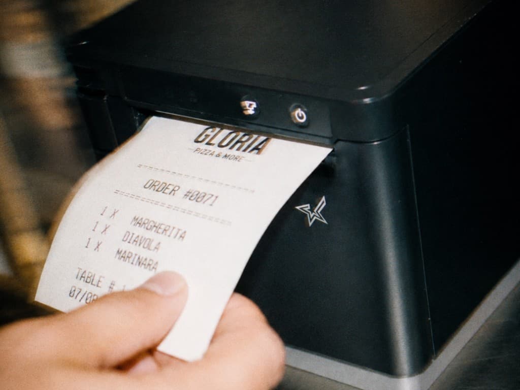 Square POS with Gloria branding at the counter